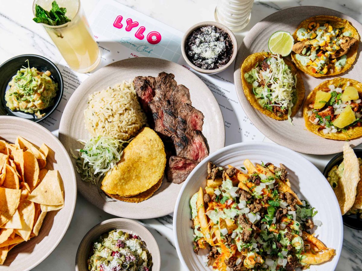 This image features various dishes including tacos, nachos, fries topped with meat and vegetables, a drink, and a plate with rice and meat.